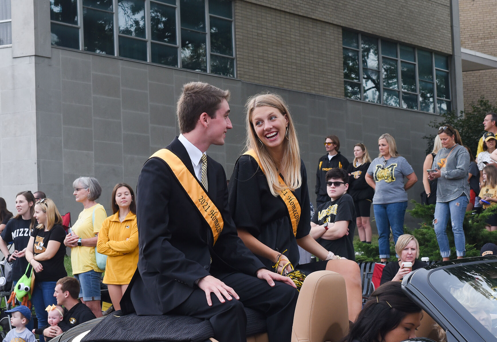 Alex Klumb (left) And Madison Herwick (right) ride in a car as part of MU’s Homecoming Royalty